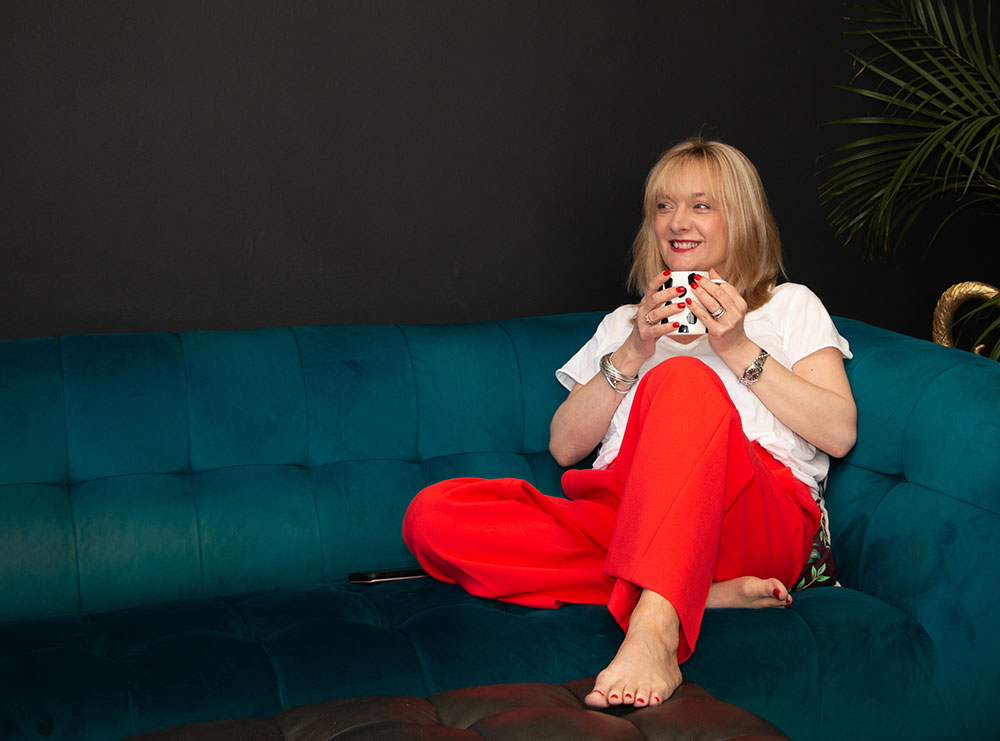 Michelle enjoying a coffee on the sofa