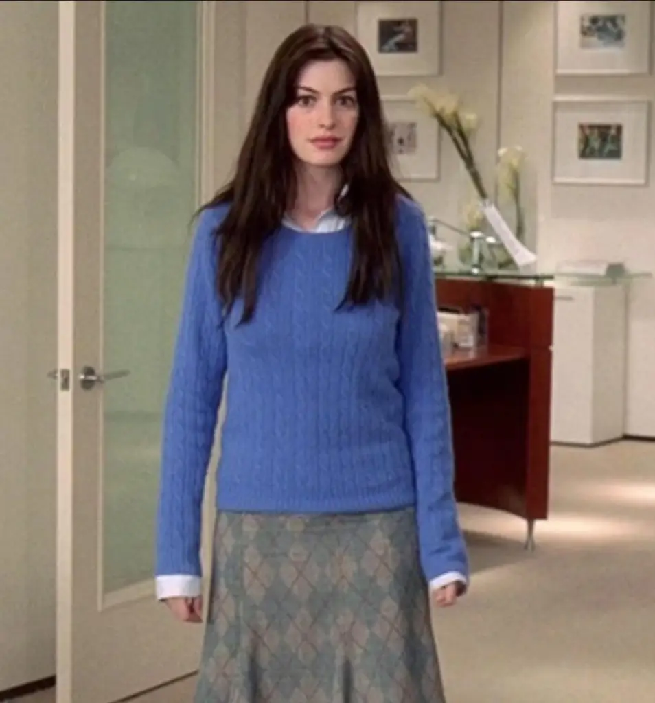 Anne Hathaway playing Andy in The Devil Wears Prada film wearing a blue (cerulean)jumper and tweed skirt