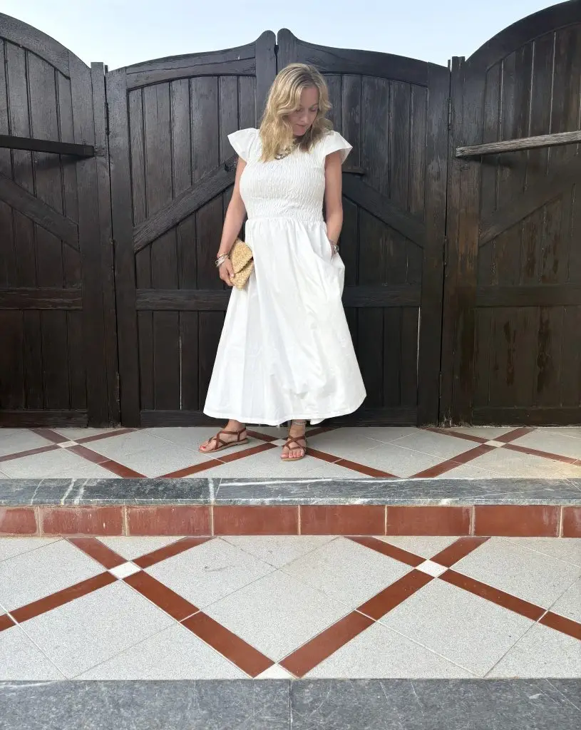 Michelle Wright wering midi length white dress